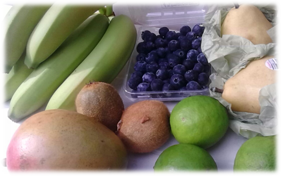 Fruit on display: blueberries at top center, pears at top right, limes at bottom right, kiwis at center left, mango at bottom left and bananas at top left.